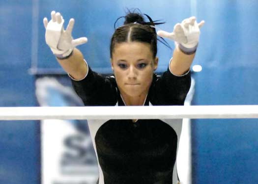 Women's Gymnastics team hoisting the 2009 National Championship trophy
